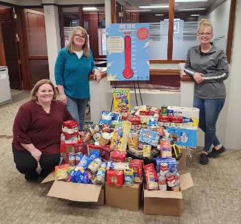 New Richmond Staff with food drive items